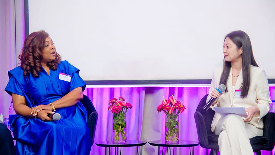 Global Alumni Ambassador Ashley is sitting on a stage with Jing who is the Engagement Officer from the University. They are at an alumni reception which was held at Radisson Blu Anchorage Hotel in Lagos, Nigeria.